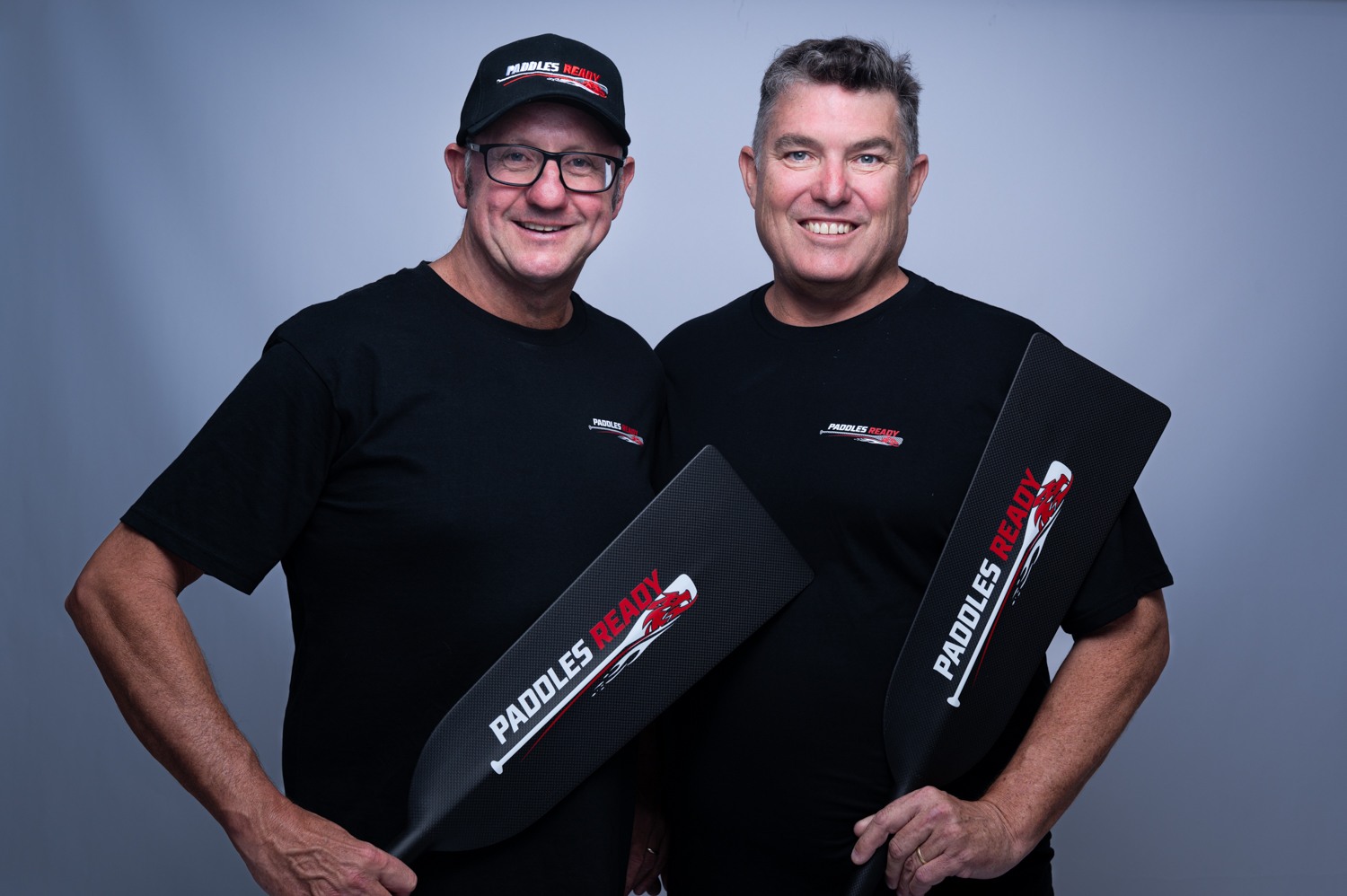 Dougie Grevett and Nick Hando holding Paddles Ready branded paddles